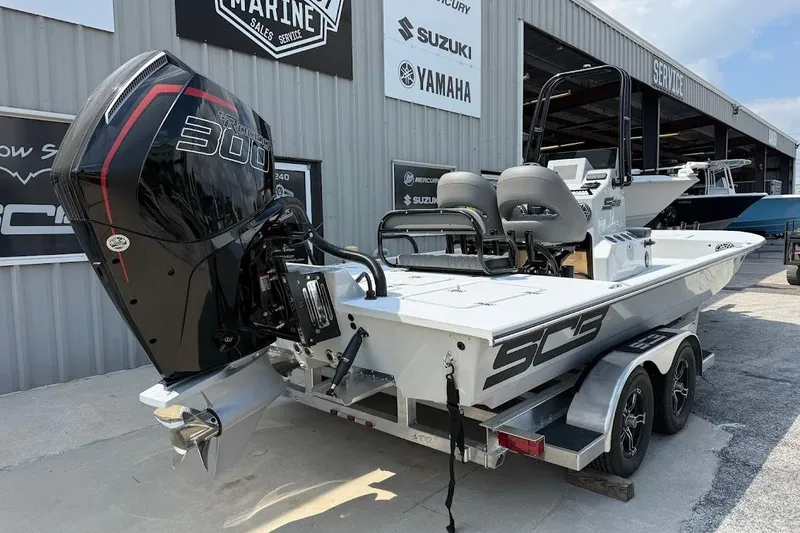 Slide: The Image of 2026 SCB S22 boat with powerful 300 horsepower engine, parked at a marine service center. - 11