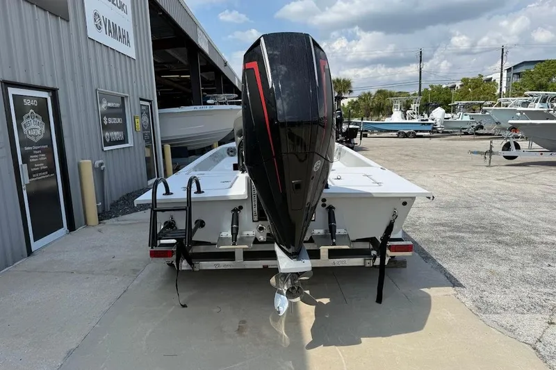 Slide: The Image of 2026 SCB S22 boat with powerful outboard motor at a marine dealership. - 12