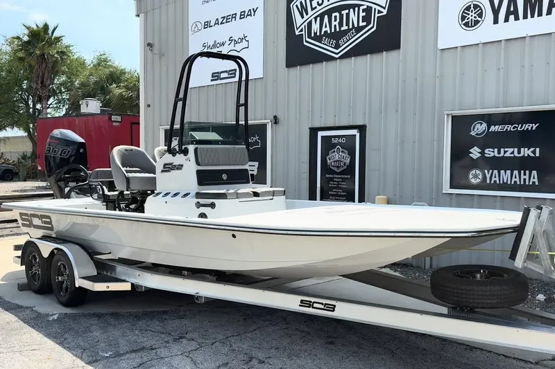 Slide: The Image of 2026 SCB S22 boat on trailer outside marine service center. - 15