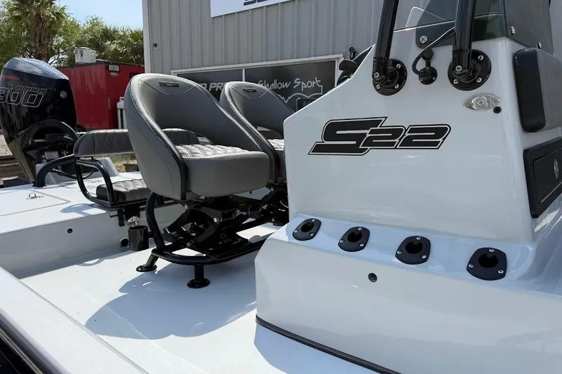 Slide: The Image of 2026 SCB S22 boat with dual seats and powerful engine, parked outdoors. - 6