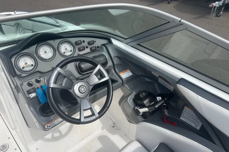 Slide: The Image of 2015 Yamaha Boats SX210 dashboard with steering wheel and control panel. - 10