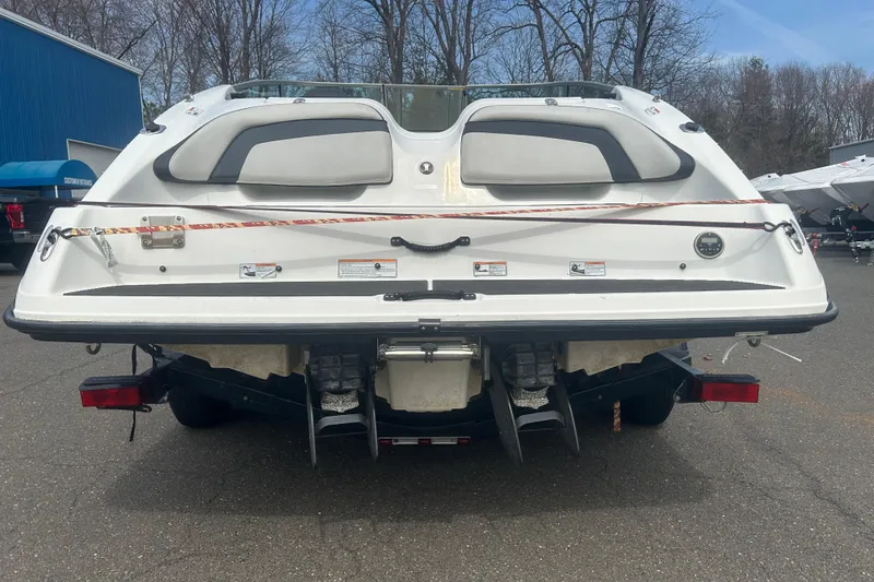 Slide: The Image of 2015 Yamaha Boats SX210 rear view, parked outdoors on a trailer. - 7