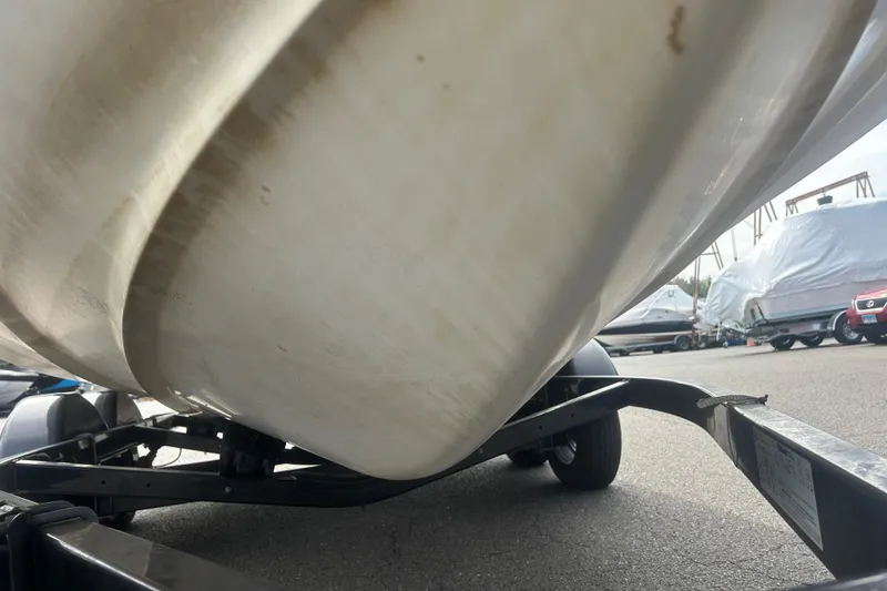 Slide: The Image of 2015 Yamaha Boats SX210 on trailer, close-up of hull and wheels. - 8