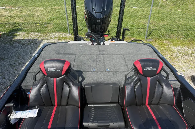 Slide: The Image of 2026 Skeeter ZXE21 boat interior with black and red seats, outdoor setting. - 14