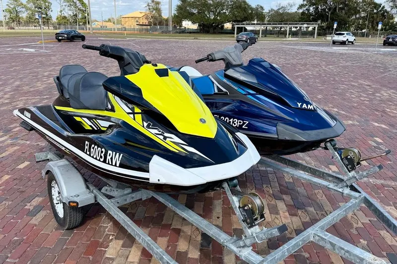 Slide: The Image of Two 2019 Yamaha WaveRunner VX Deluxe jet skis on a trailer in a parking lot. - 3