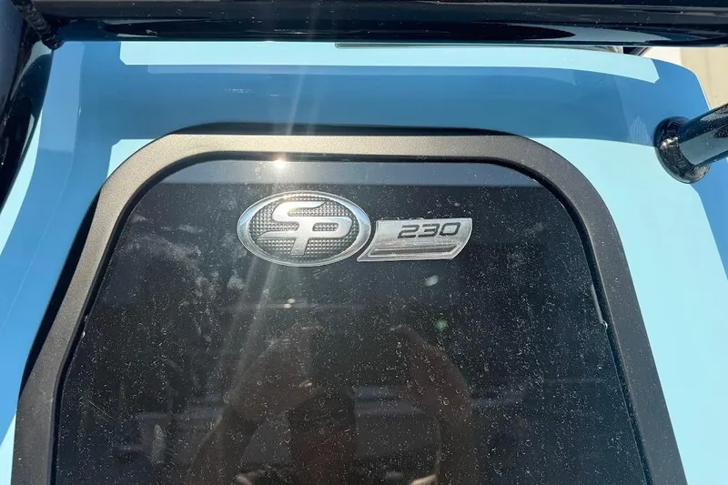 Slide: The Image of 2026 Sea Pro 230 Bay boat emblem on a blue surface. - 13