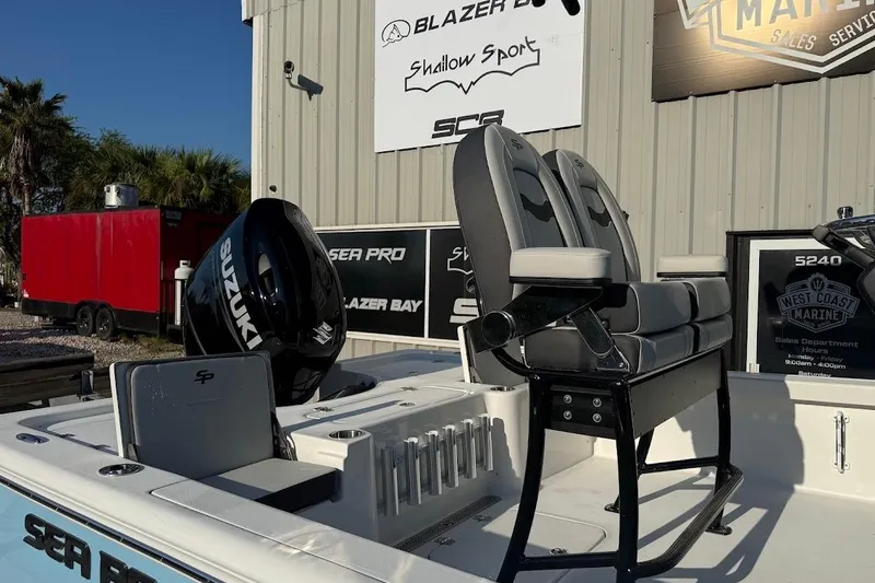 Slide: The Image of 2026 Sea Pro 230 Bay boat with Suzuki engine, displayed at a marine dealership. - 5