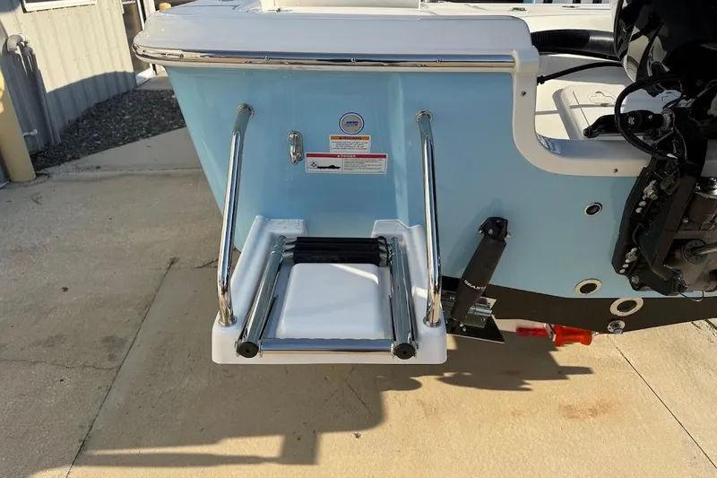 Slide: The Image of 2026 Sea Pro 230 Bay boat with a foldable swim ladder and outboard motor. - 7