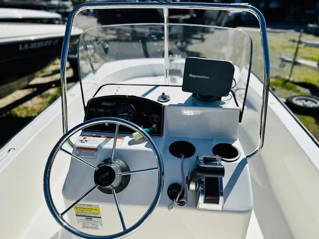 Slide: The Image of 2010 Boston Whaler 150 Montauk boat console with steering wheel and navigation equipment. - 10