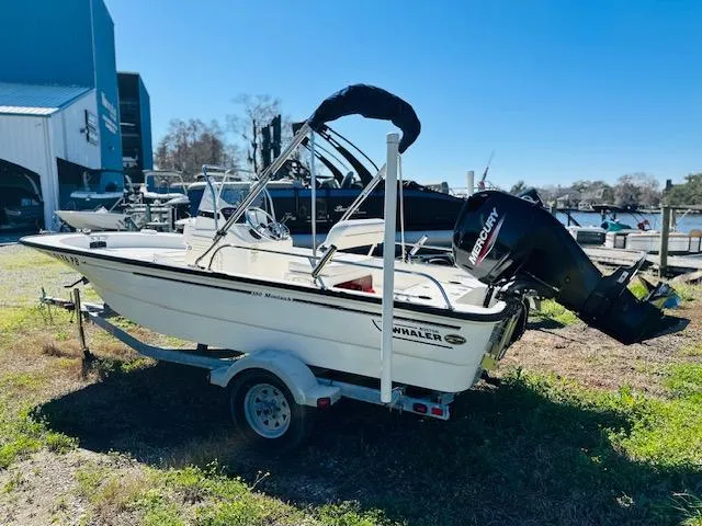 Slide: The Image of 2010 Boston Whaler 150 Montauk boat on trailer with Mercury outboard motor. - 7