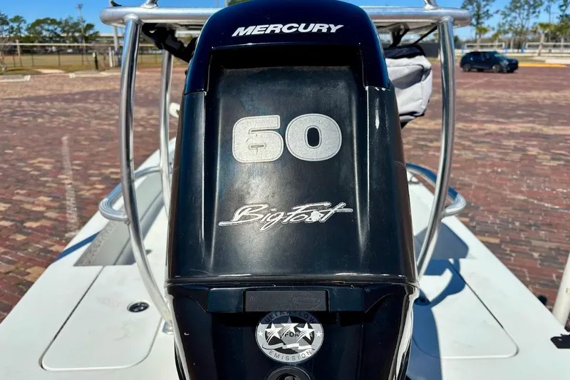 Slide: The Image of Mercury 60 BigFoot engine on 2009 Ranger Banshee boat, parked on brick surface. - 16