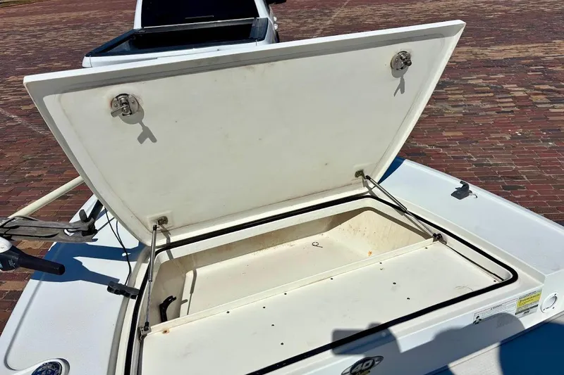 Slide: The Image of Open storage compartment on a 2009 Ranger Banshee boat, showing interior details. - 7
