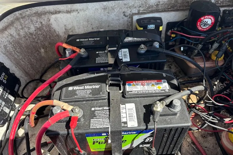 Slide: The Image of Four West Marine batteries connected with cables in a 2009 Ranger Banshee boat. - 9