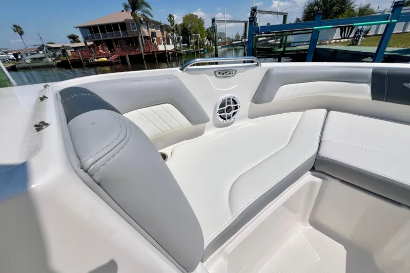 Slide: The Image of 2023 Chaparral 23 SSi OB boat interior with white seating and speaker. - 18