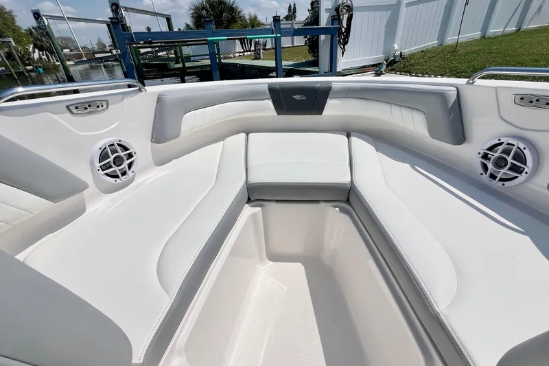 Slide: The Image of 2023 Chaparral 23 SSi OB boat interior with white seating and speakers. - 19