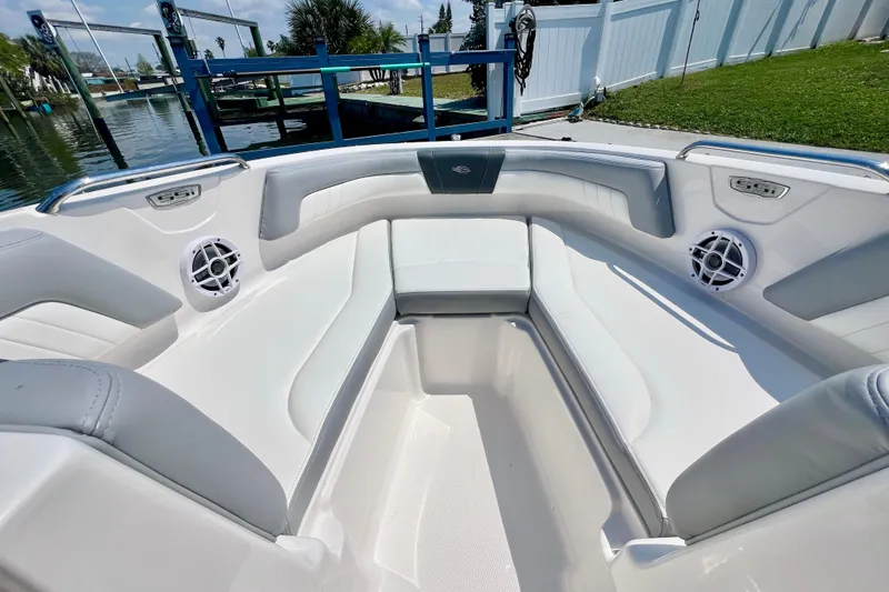 Slide: The Image of 2023 Chaparral 23 SSi OB boat interior with white seating and speakers. - 21