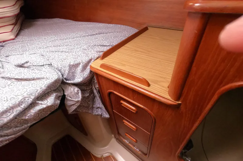 Slide: The Image of Cozy cabin interior of 1982 Irwin 34 Citation sailboat with wooden cabinetry and patterned bedding. - 17
