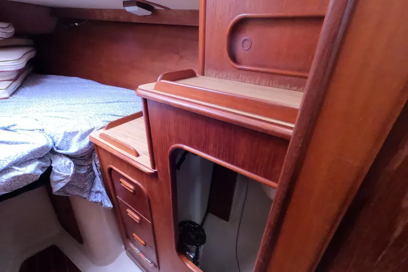 Slide: The Image of Interior of 1982 Irwin 34 Citation sailboat with wooden cabinetry and cozy bedding. - 18