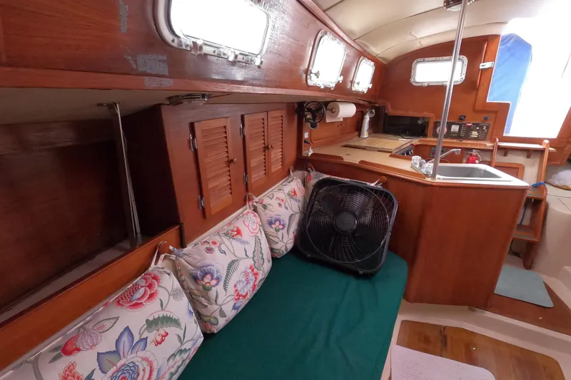 Slide: The Image of Interior of 1982 Irwin 34 Citation sailboat with cozy seating and wooden cabinetry. - 21