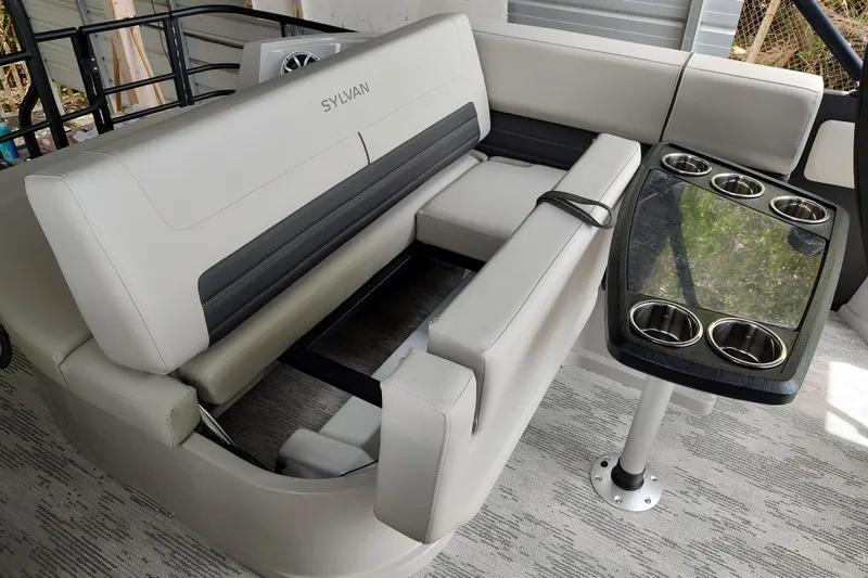 Slide: The Image of Luxurious Sylvan G3 CLZ DH 2026 boat interior with plush seating and cupholder table. - 7