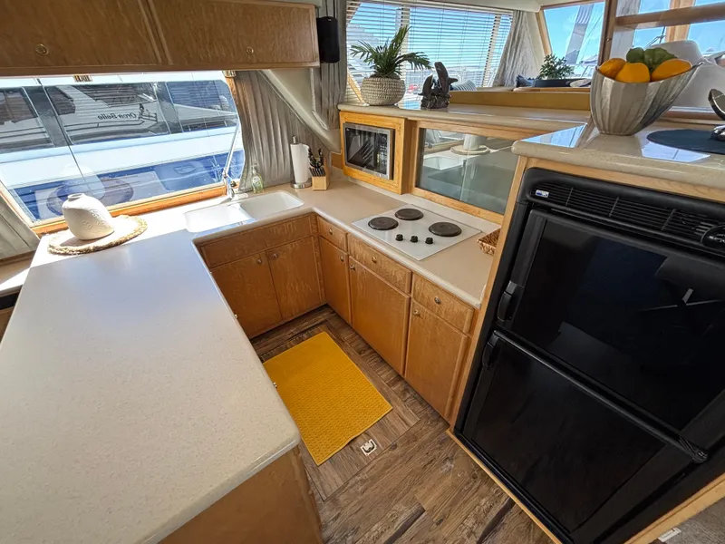 Slide: The Image of Navigator 5300 yacht kitchen, 2000 model, featuring modern appliances and wooden cabinetry. - 11