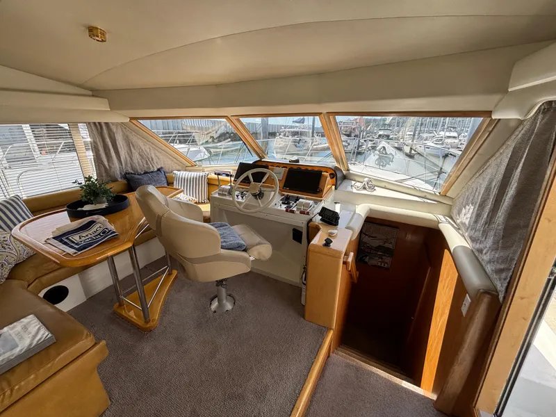 Slide: The Image of Interior of 2000 Navigator 5300 yacht with helm, seating, and panoramic windows. - 15