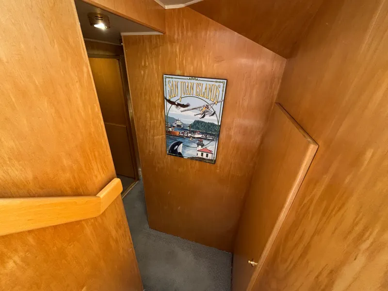 Slide: The Image of Interior hallway of 2000 Navigator 5300 yacht with wooden paneling and wall art. - 16