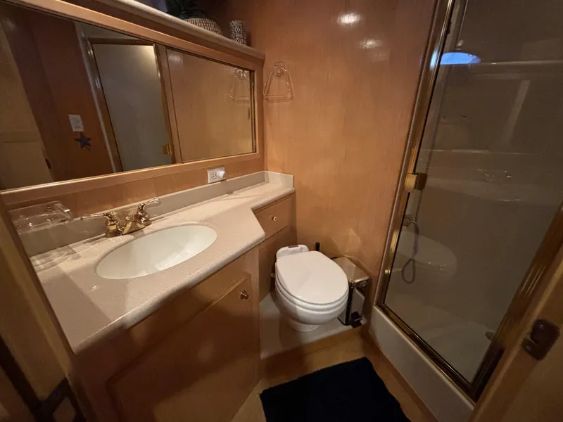 Slide: The Image of Luxurious bathroom in 2000 Navigator 5300 yacht with sink, toilet, and shower. - 19