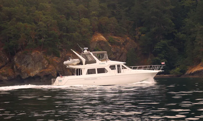 Slide: The Image of Navigator 5300 yacht cruising near forested coastline, 2000 model. - 2