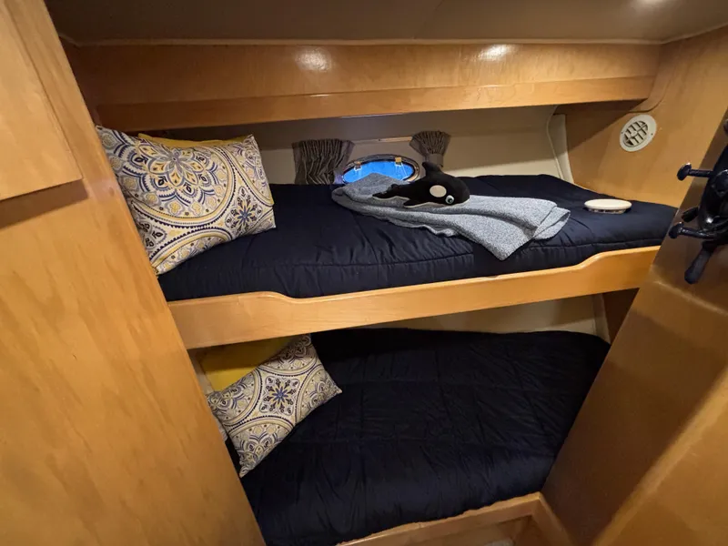 Slide: The Image of Bunk beds in 2000 Navigator 5300 yacht cabin with decorative pillows and cozy bedding. - 20