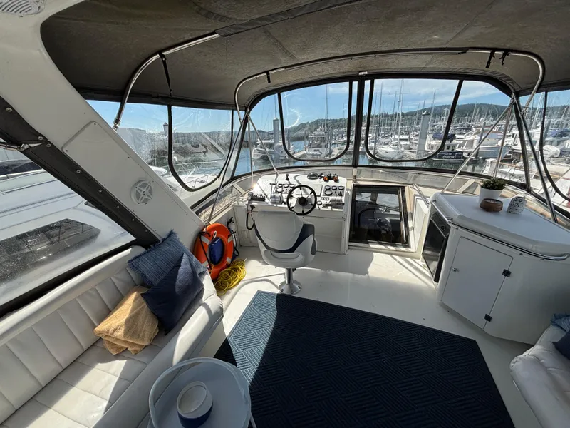 Slide: The Image of Interior of 2000 Navigator 5300 yacht with helm, seating, and marina view. - 26