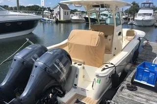 Slide: The Image of 2018 Scout 255 LXF boat docked with twin Yamaha engines in a marina. - 1