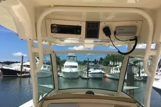 Slide: The Image of Interior view of 2018 Scout 255 LXF boat with marina background. - 10