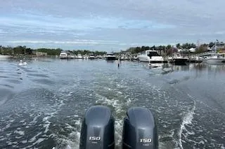 Slide: The Image of 2018 Scout 255 LXF boat cruising on a calm waterway with twin 150 engines. - 12