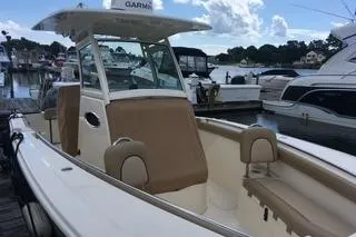 Slide: The Image of 2018 Scout 255 LXF boat docked at marina with clear skies. - 4