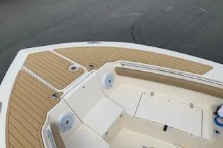 Slide: The Image of 2018 Scout 255 LXF boat deck with wood finish and seating area. - 5