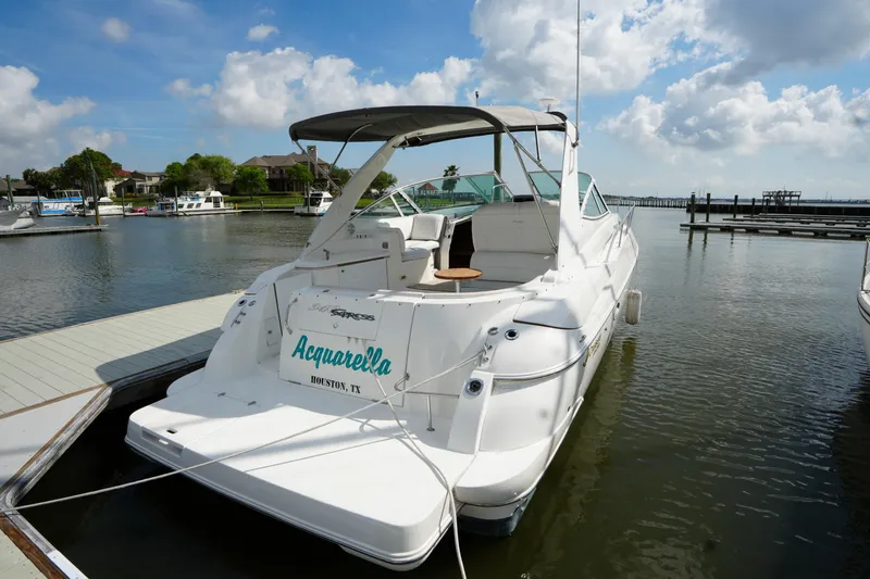 The Image of 2005 CRUISERS YACHT 340 Express docked at marina under blue sky. - 1