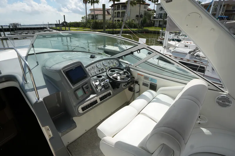 Slide: The Image of 2005 CRUISERS YACHT 340 Express helm with modern controls and luxurious seating. - 10