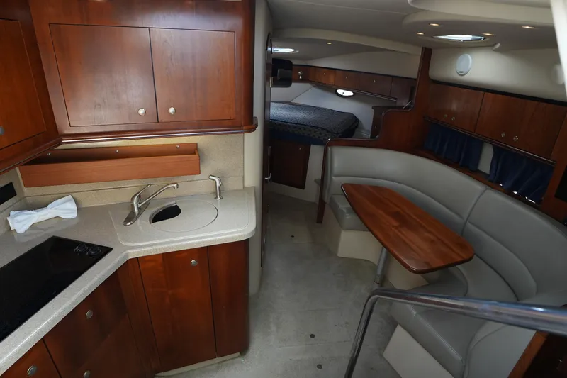 Slide: The Image of 2005 Cruisers Yacht 340 Express interior with kitchen, seating, and sleeping area. - 13