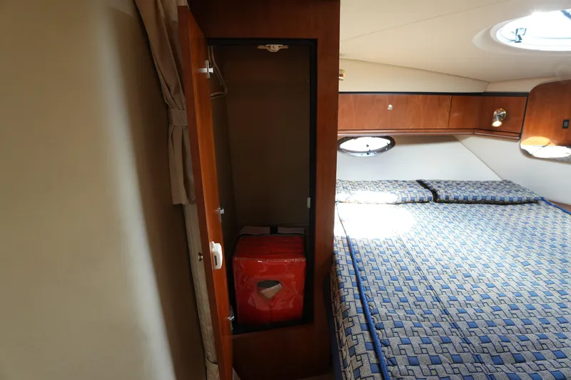 Slide: The Image of 2005 CRUISERS YACHT 340 Express cabin with bed, closet, and porthole window. - 15