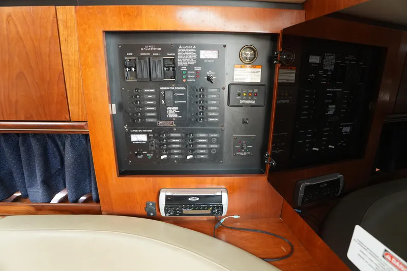 Slide: The Image of Electrical control panel inside 2005 CRUISERS YACHT 340 Express, featuring switches and gauges. - 20