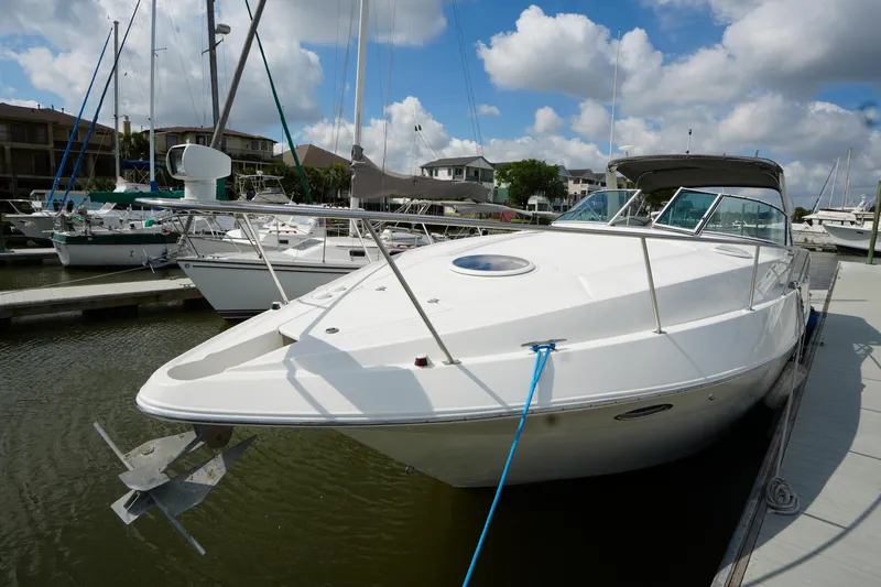 Slide: The Image of 2005 CRUISERS YACHT 340 Express docked at marina under blue sky. - 3