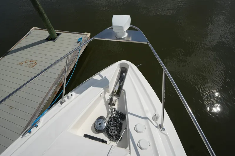 Slide: The Image of Bow view of 2005 CRUISERS YACHT 340 Express docked, showing anchor and railing. - 4