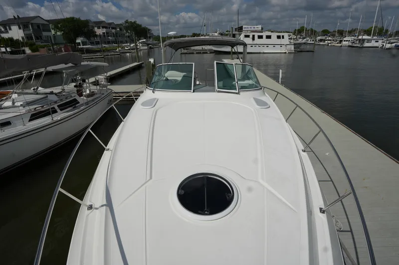 Slide: The Image of 2005 CRUISERS YACHT 340 Express docked at marina under cloudy sky. - 5