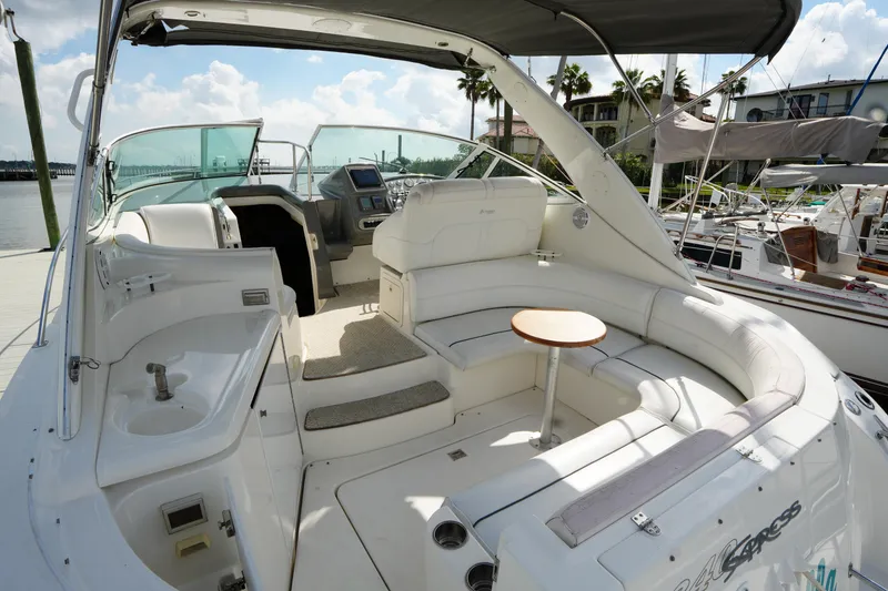 Slide: The Image of 2005 Cruisers Yacht 340 Express interior with seating and helm, docked at marina. - 8