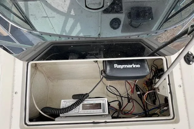 Slide: The Image of 2006 Striper 2301 Walkaround OB boat dashboard with Raymarine electronics and wiring. - 11