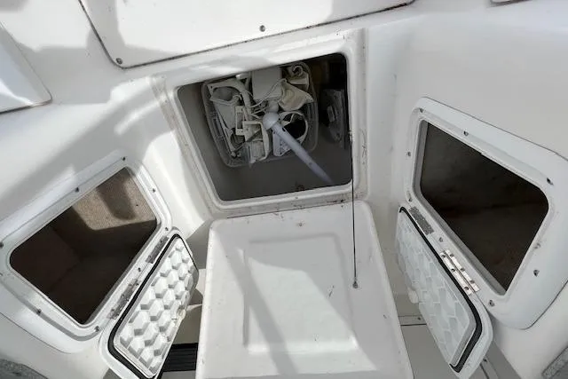Slide: The Image of Storage compartments on a 2006 Striper 2301 Walkaround OB boat interior. - 13