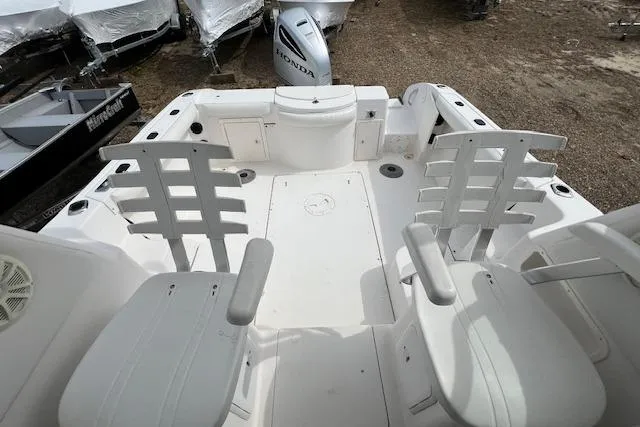 Slide: The Image of 2006 Striper 2301 Walkaround OB boat interior with seating and storage compartments. - 14