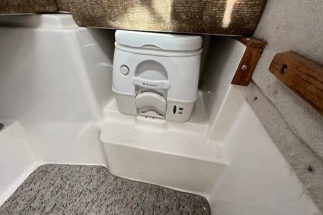 Slide: The Image of 2006 Striper 2301 Walkaround OB boat interior with portable toilet. - 18