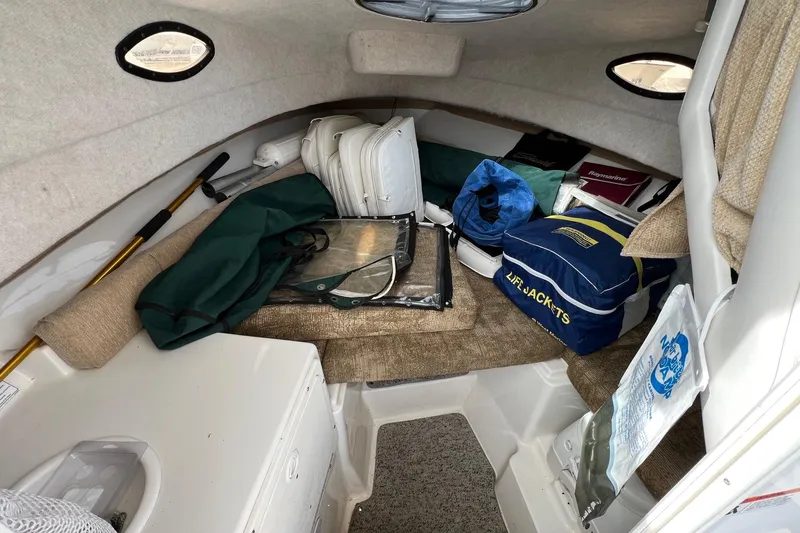 Slide: The Image of Interior cabin of 2006 Striper 2301 Walkaround OB with stored gear and life jackets. - 19